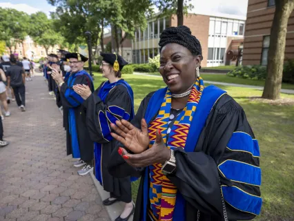 Faculty cheer on students in full academic regalia
