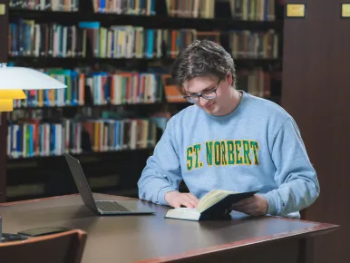 A student at St. Norbert College studies at the library.