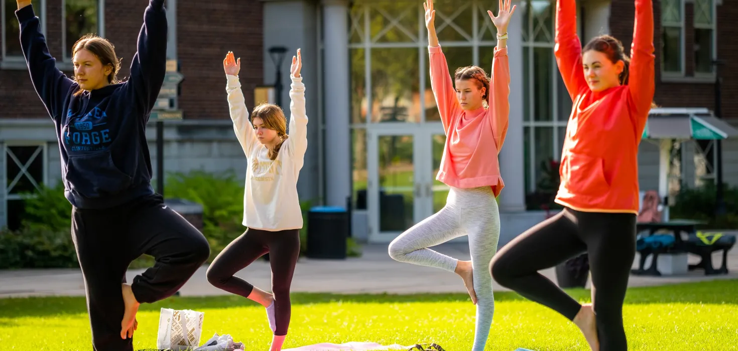 Students doing yoga on the Campus Center lawn