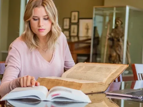 Former student Elle Maricque translating Latin text.