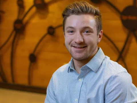 Logan Hennes '22 poses inside the science building