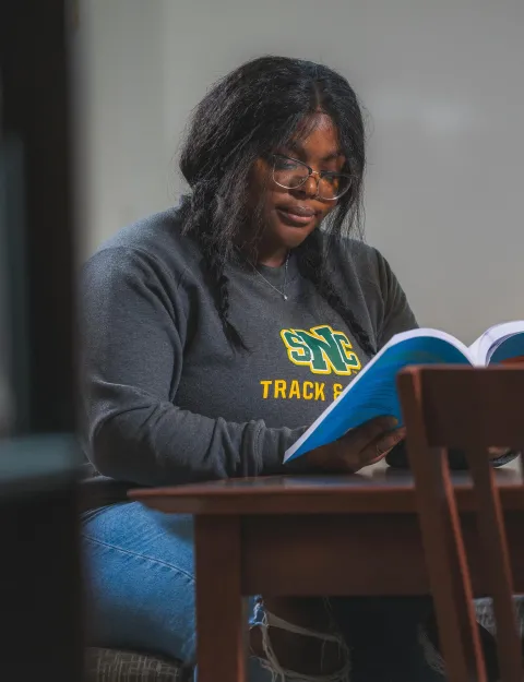 A student studies at the Mulva Library at SNC