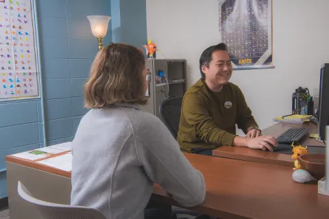 An academic advisor works with an SNC student