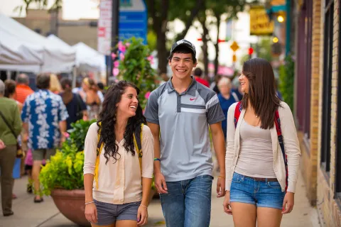 Three people walking in downtown Green Bay