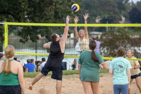 Students playing intramural sand volleyball