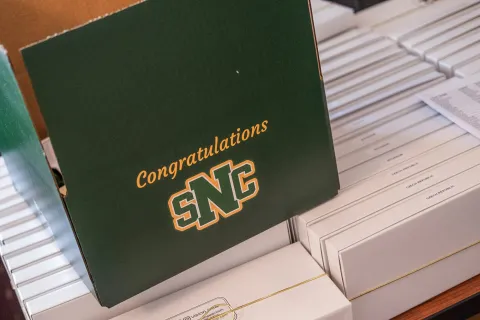 A green box with the SNC monogram logo and the words "Congratulations!"