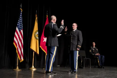 A graduate of the ROTC program is commissioned on stage