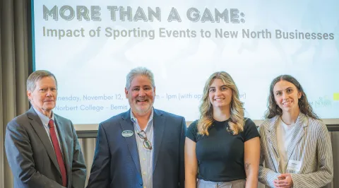 Casey Mayew ’27 and Jaden Propson ’27, along with dean of the Donald J. Schneider School of Business & Economics Kevin Quinn