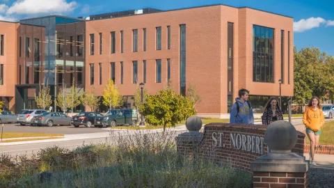 Schneider Family Hall with students walking past