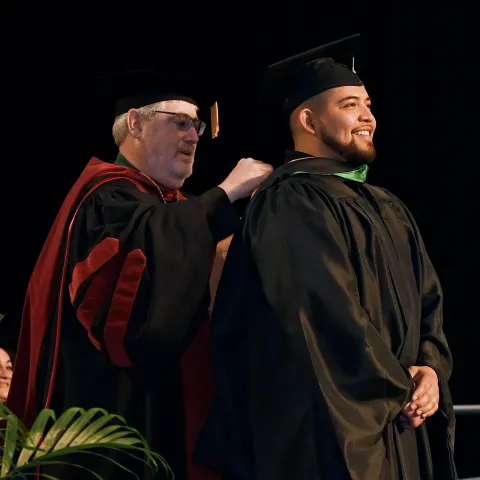 José Villa MBA ’24 receives his MBA hood at graduation